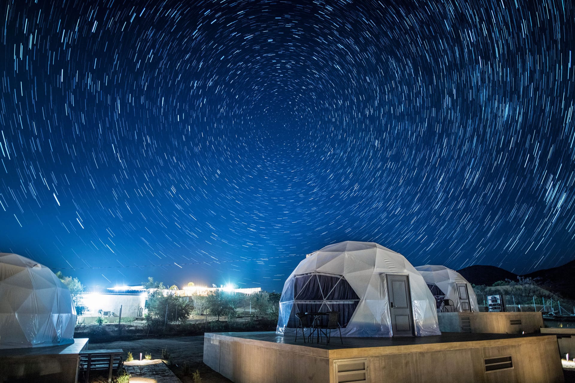 Featured glamping dome experience with guest enjoying the view
