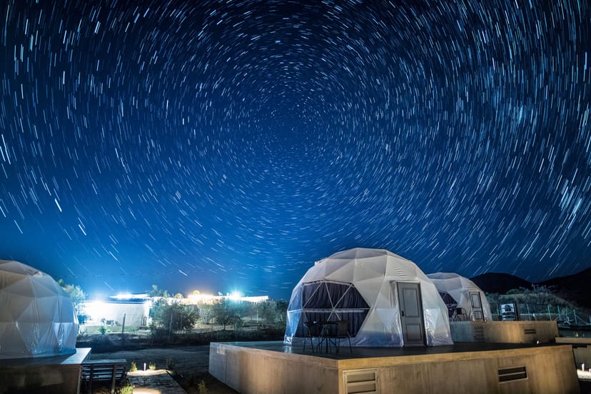 Featured glamping dome experience with guest enjoying the view